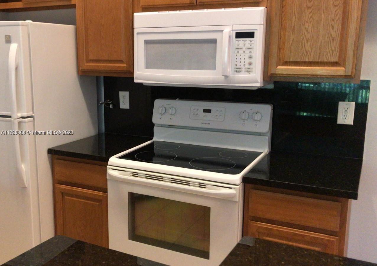 Summerbreeze Condominiums Sunrise, FL 33322 - Photo 6 of 12 a stove top oven sitting inside of a kitchen
