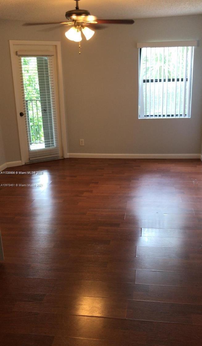 Summerbreeze Condominiums Sunrise, FL 33322 - Photo 10 of 12 an empty room with wooden floor and windows