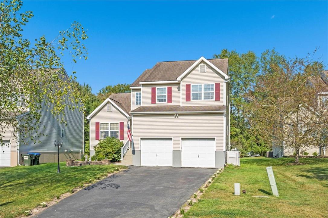 23 Reed Court Washingtonville, NY 10992 - Photo 1 of 1 View of front of house with a garage and a front yard