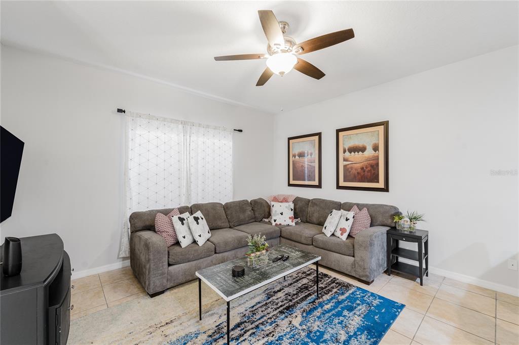 8961 Majesty Palm Road Kissimmee, FL 34747 - Photo 13 of 40 a living room with furniture and a rug