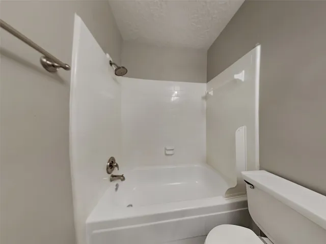 a bathroom with a bathtub and shower
