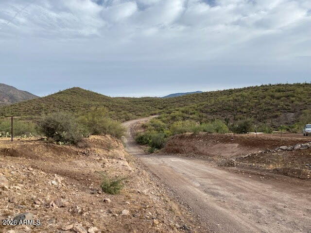 7b North Cow Creek Road, Unit 7B Morristown, AZ 85342 - Photo 18 of 18 a view of a road with mountains in the background