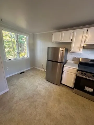 a kitchen with stainless steel appliances a refrigerator and a stove top oven