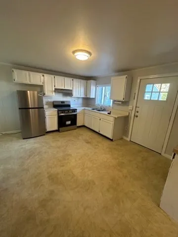 a kitchen with a refrigerator sink and stove