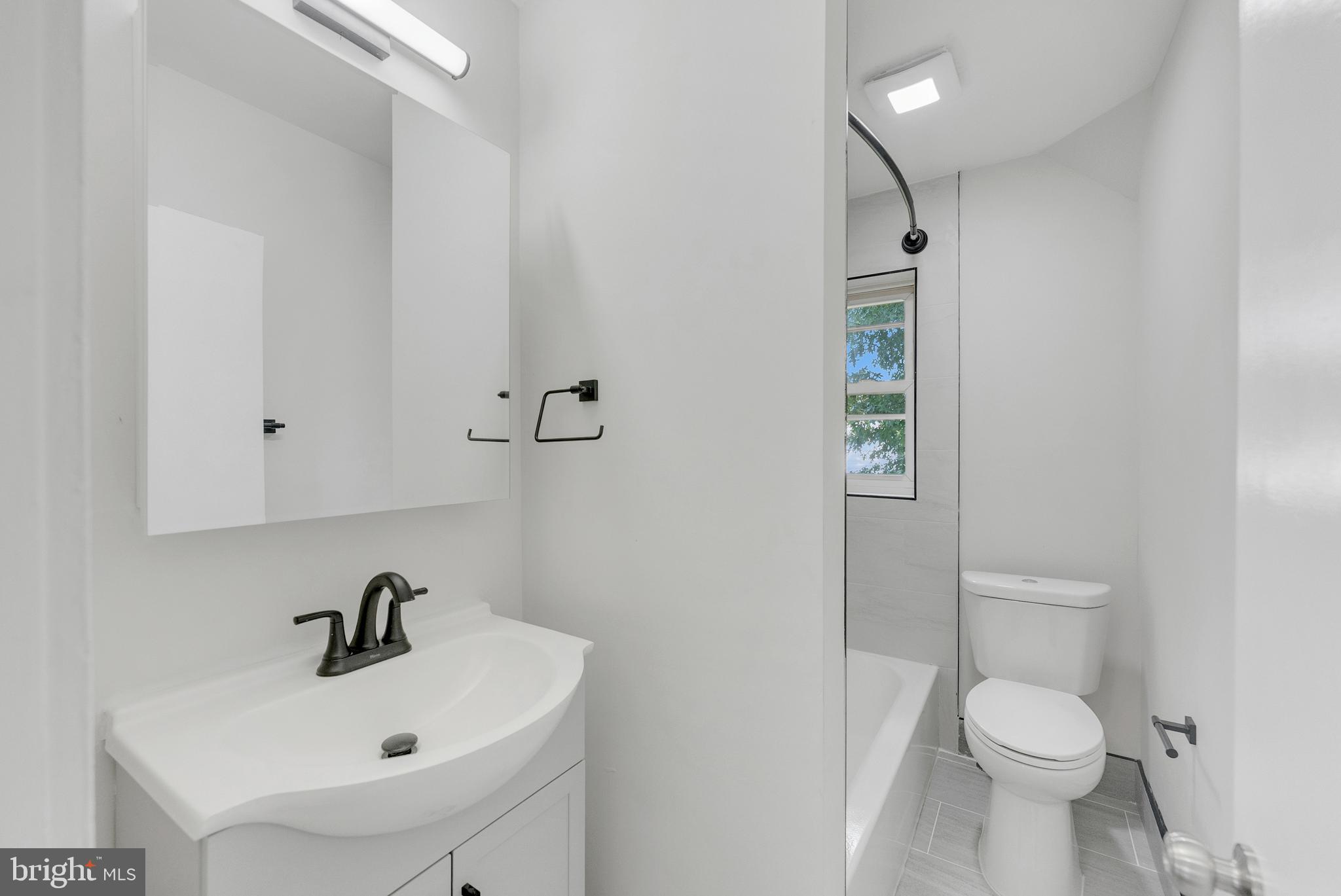 217 Pennsylvania Road Brooklawn, NJ 08030 - Photo 13 of 21 a bathroom with a sink toilet and a mirror