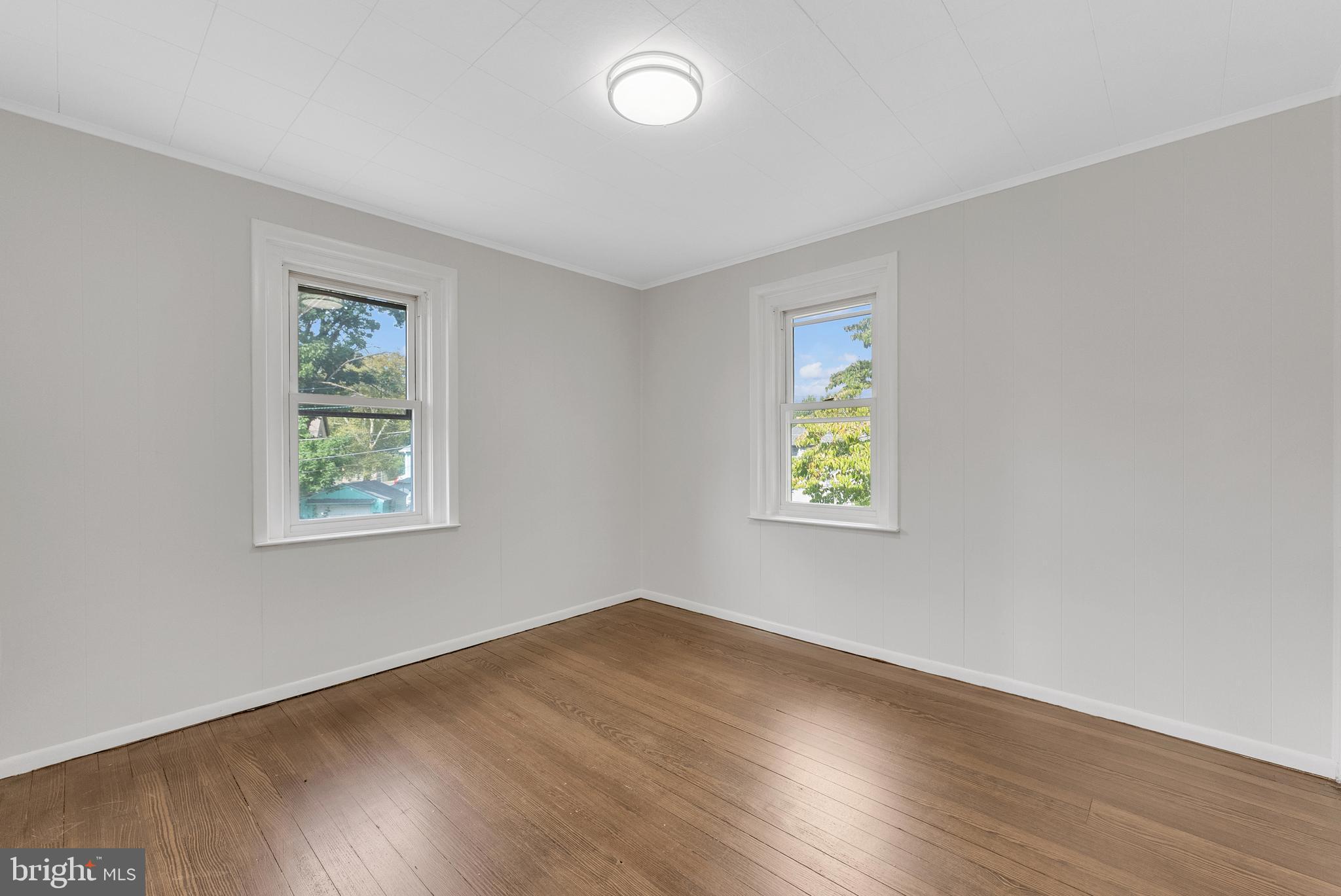 217 Pennsylvania Road Brooklawn, NJ 08030 - Photo 14 of 21 a view of room with window and wooden floor