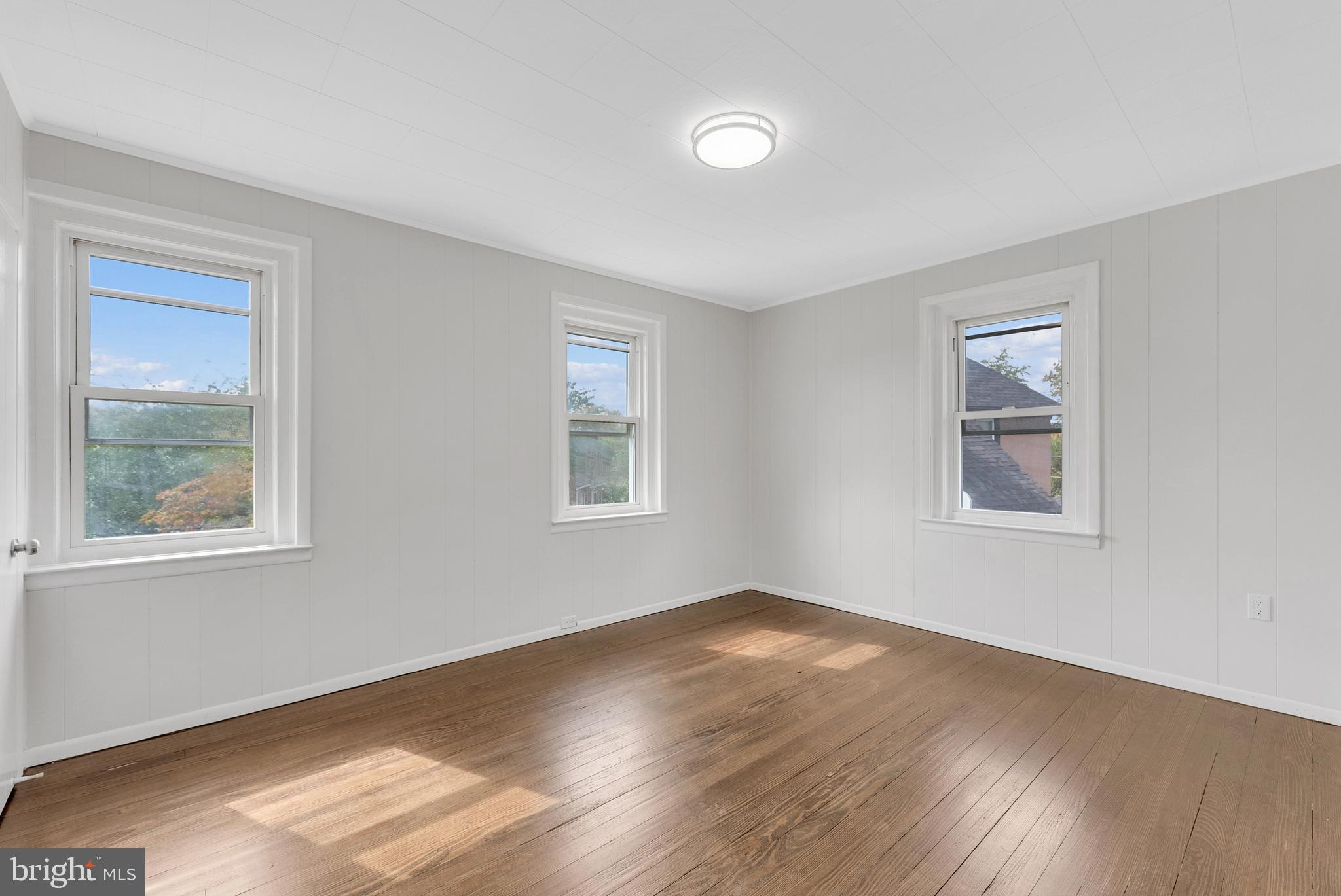 217 Pennsylvania Road Brooklawn, NJ 08030 - Photo 15 of 21 a view of an empty room with wooden floor and a window
