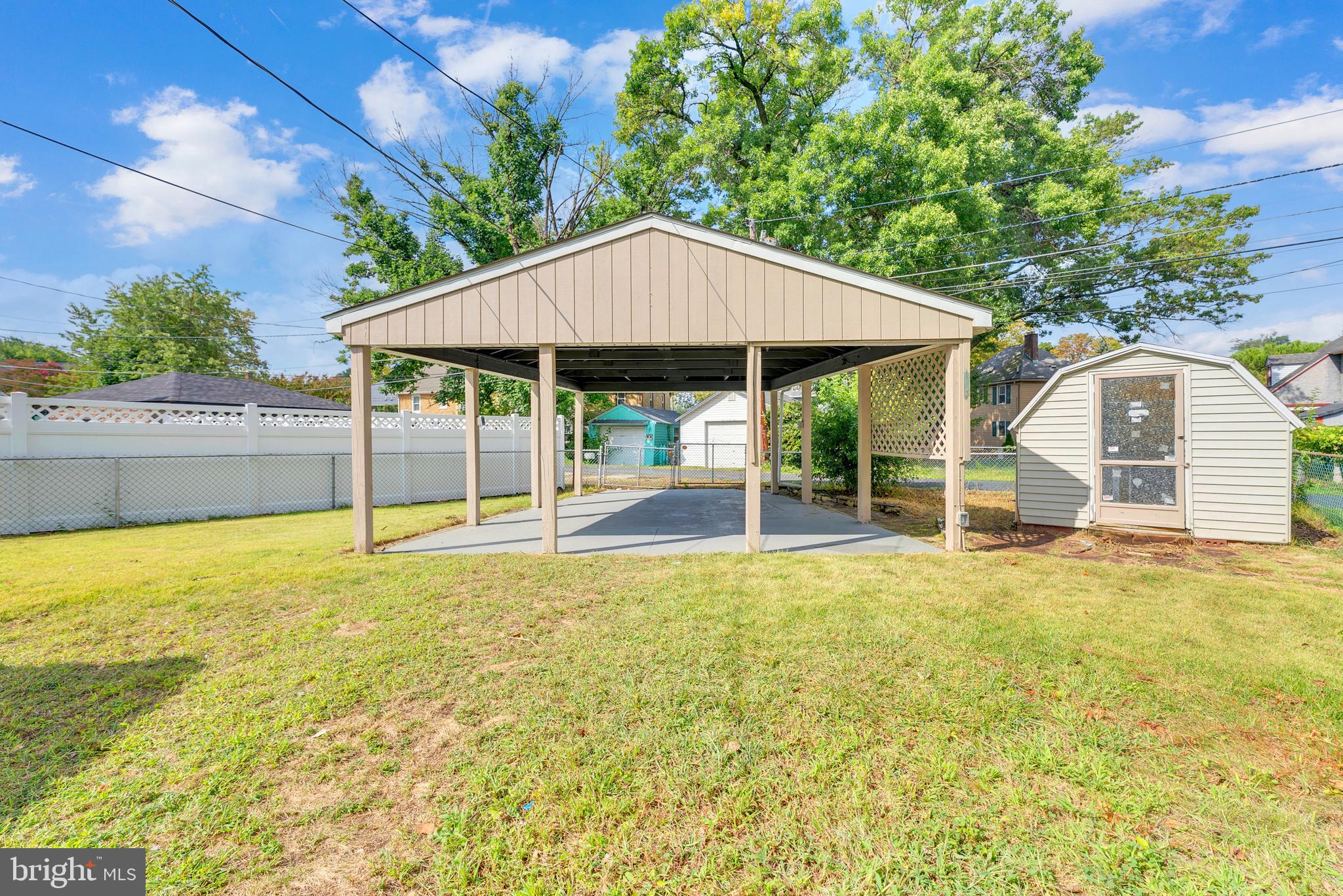 217 Pennsylvania Road Brooklawn, NJ 08030 - Photo 19 of 21 a backyard of a house with table and chairs under an umbrella