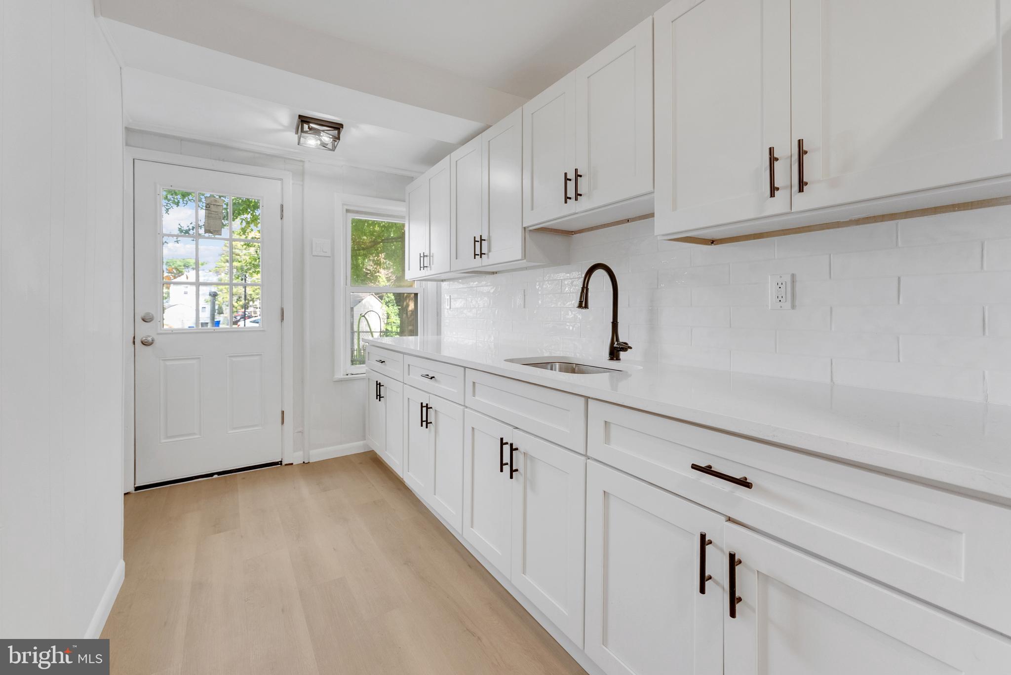217 Pennsylvania Road Brooklawn, NJ 08030 - Photo 9 of 21 a kitchen with granite countertop white cabinets and window