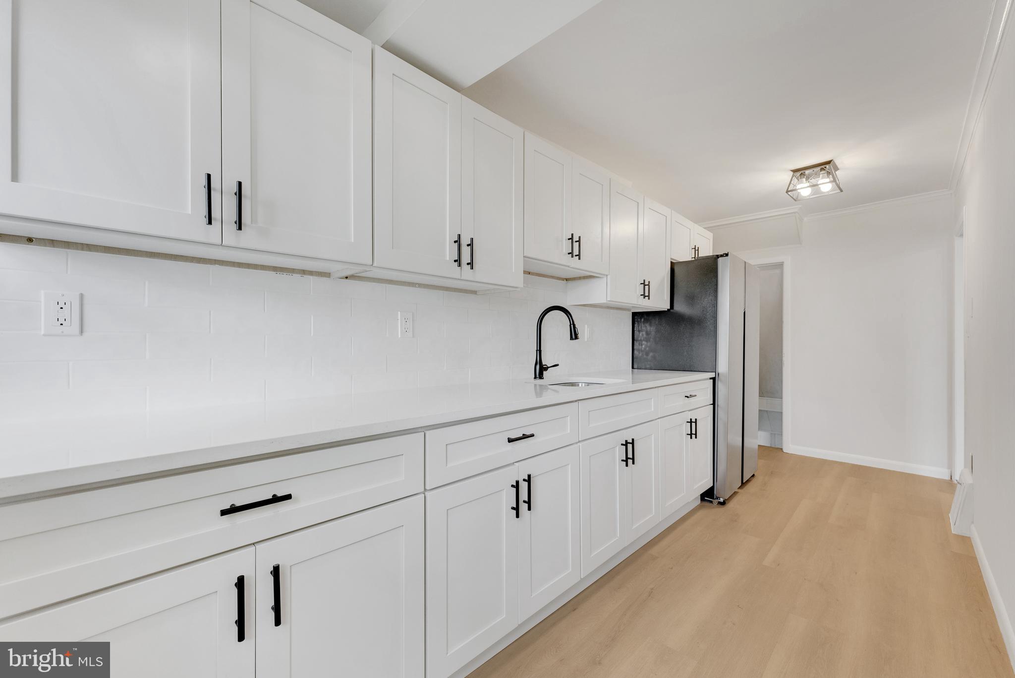 217 Pennsylvania Road Brooklawn, NJ 08030 - Photo 10 of 21 a kitchen with white cabinets and sink