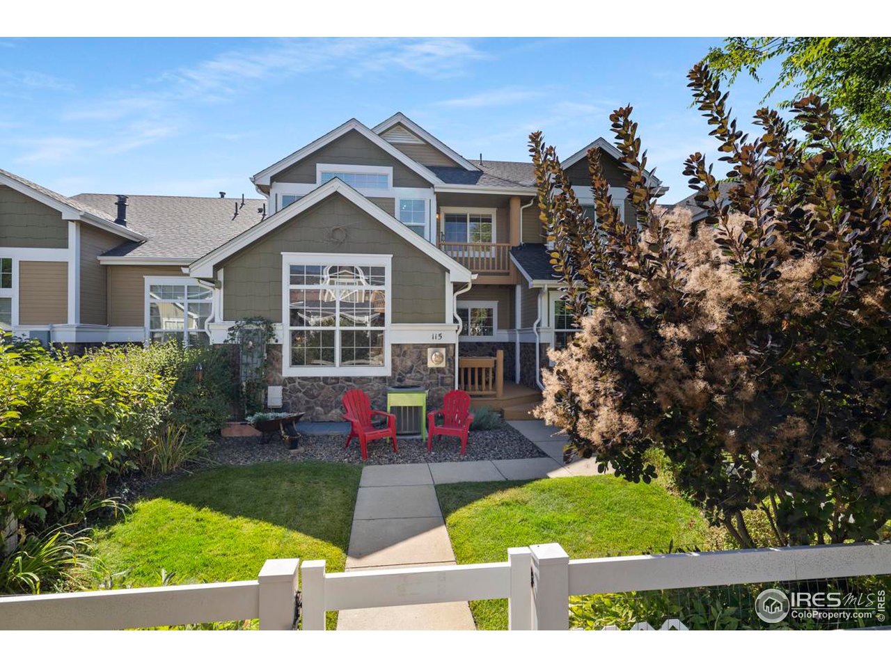 115 Bayside Circle Windsor, CO 80550 - Photo 1 of 23 a front view of a house with a yard