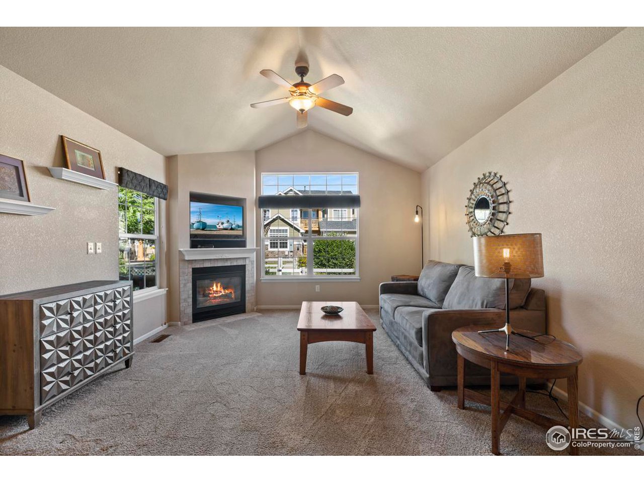 115 Bayside Circle Windsor, CO 80550 - Photo 4 of 23 a living room with furniture and a large window