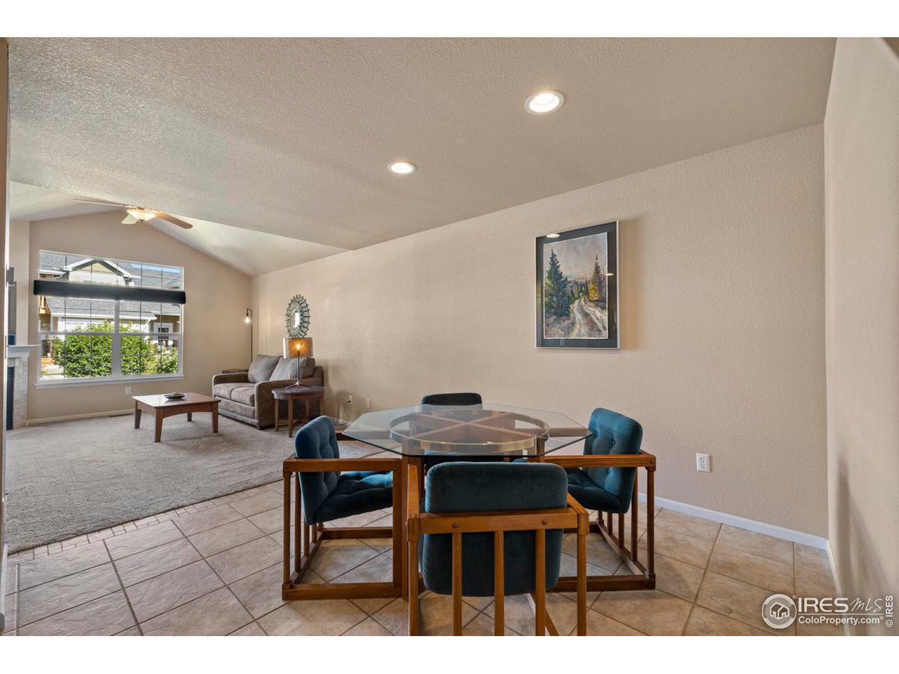 115 Bayside Circle Windsor, CO 80550 - Photo 6 of 23 a view of a dining room with furniture and a potted plant