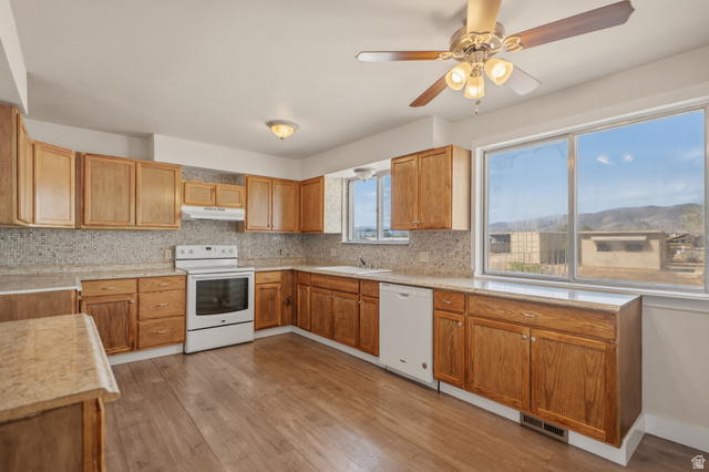 337 North Main Street Central Valley, UT 84754 - Photo 15 of 40 Kitchen with white appliances, a ceiling fan, tasteful backsplash, light wood finished floors, and wood finish cabinets