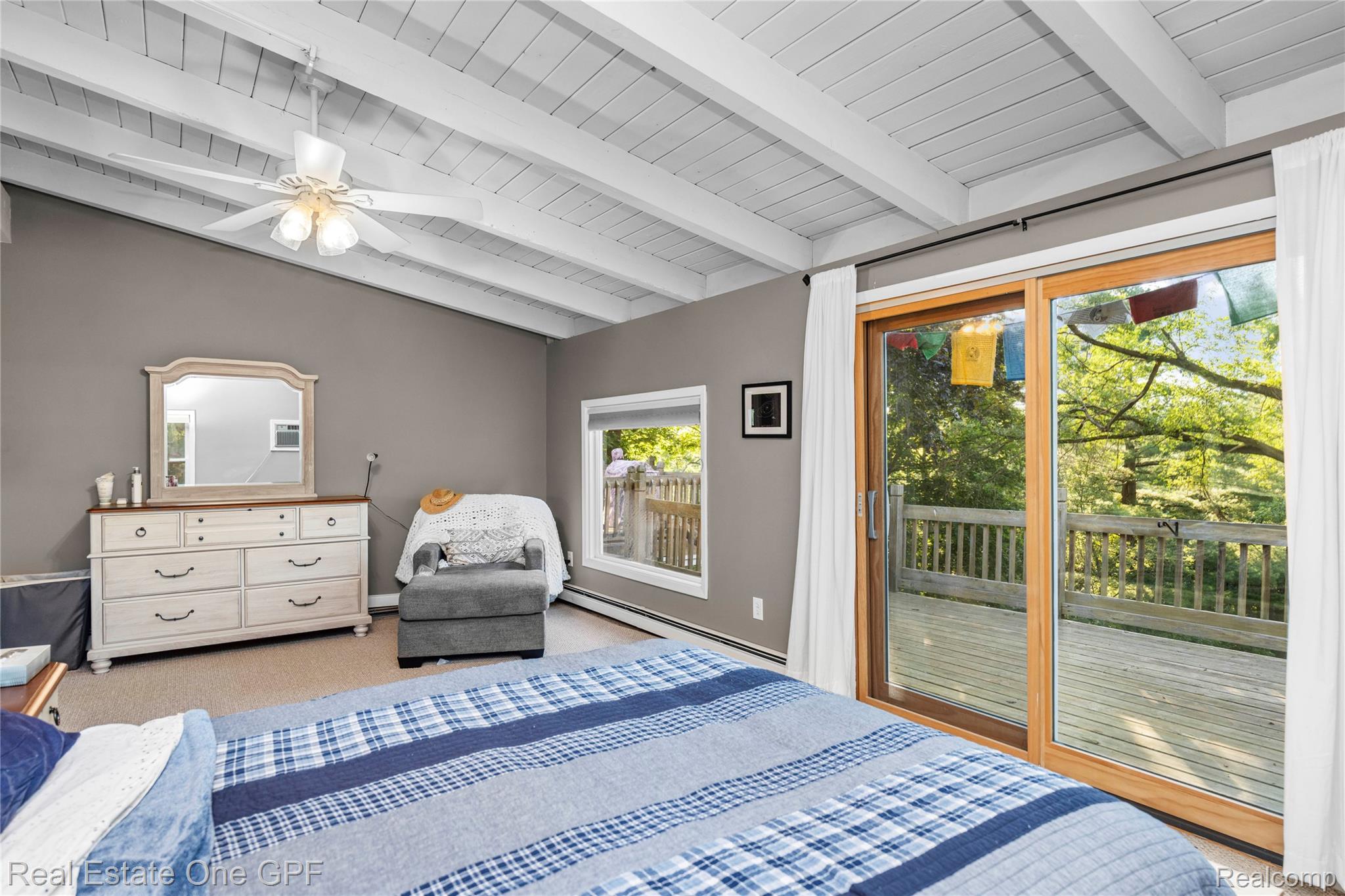 5068 Atkins Road North Street, MI 48049 - Photo 29 of 78 Vaulted ceiling with exposed beams, ceiling fan, and sliding glass door to exterior deck