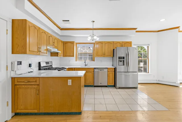 a kitchen with a sink a stove cabinets and counter space