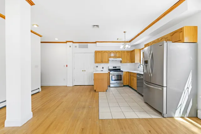 a kitchen with a refrigerator a stove top oven a sink and dishwasher