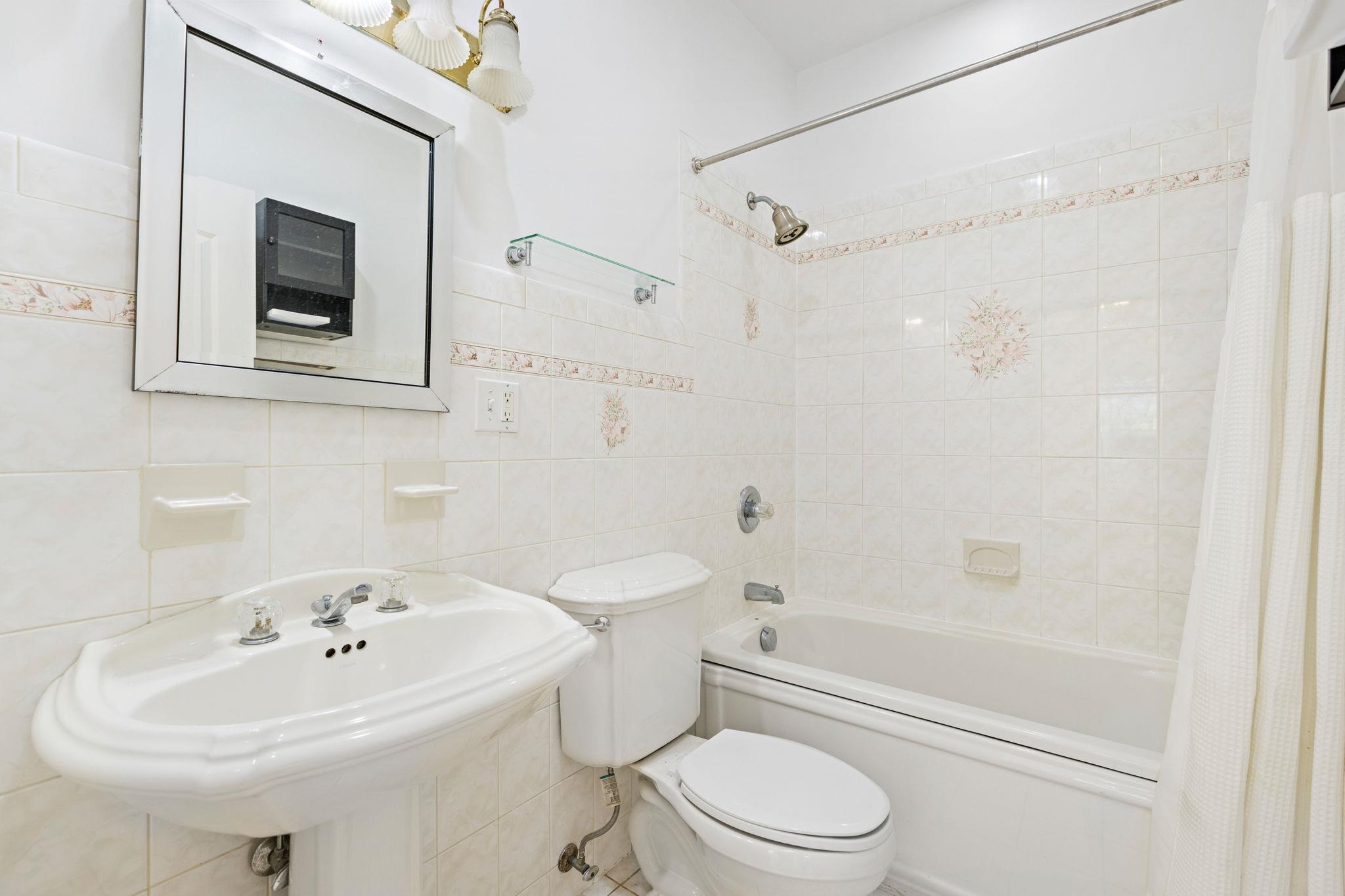 600 Grand Street, Unit 2 Hoboken, NJ 07030 - Photo 8 of 18 a bathroom with a sink toilet and shower
