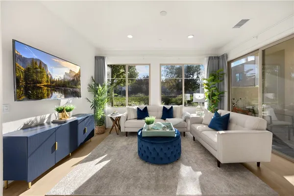 a living room with furniture and wooden floor