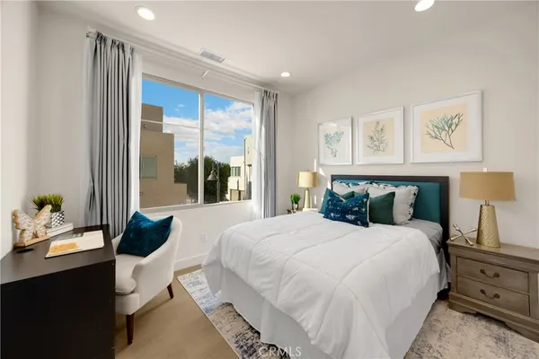 a bed sitting in a bedroom next to a window