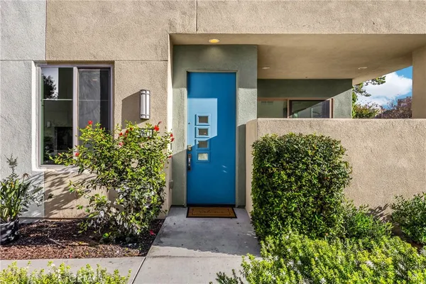 front view of a house with potted plants