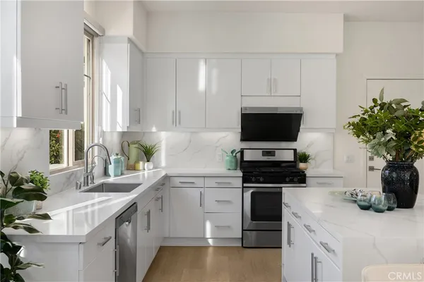 a kitchen with a sink stove and microwave