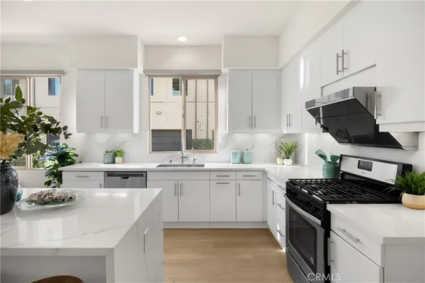 a kitchen with a sink stove and cabinets