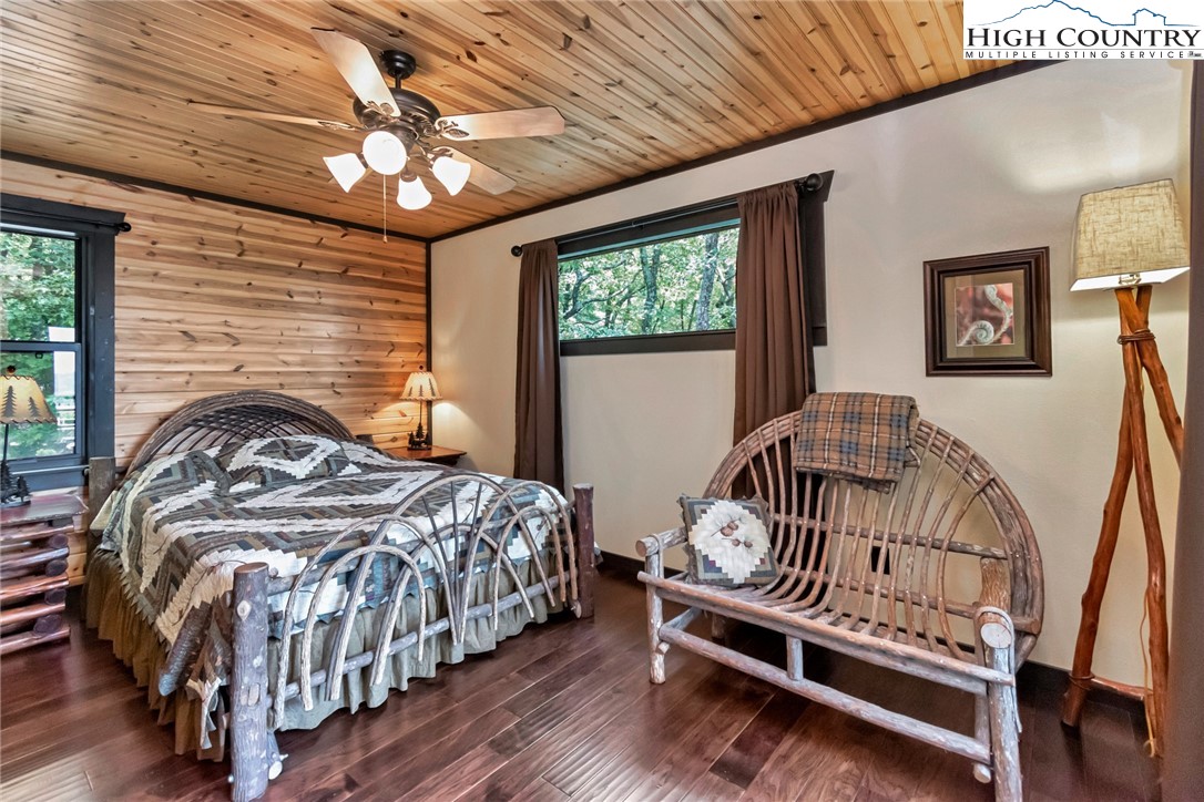 4879 Staghorn Road Purlear, NC 28665 - Photo 15 of 50 a bedroom with a bed and a chandelier