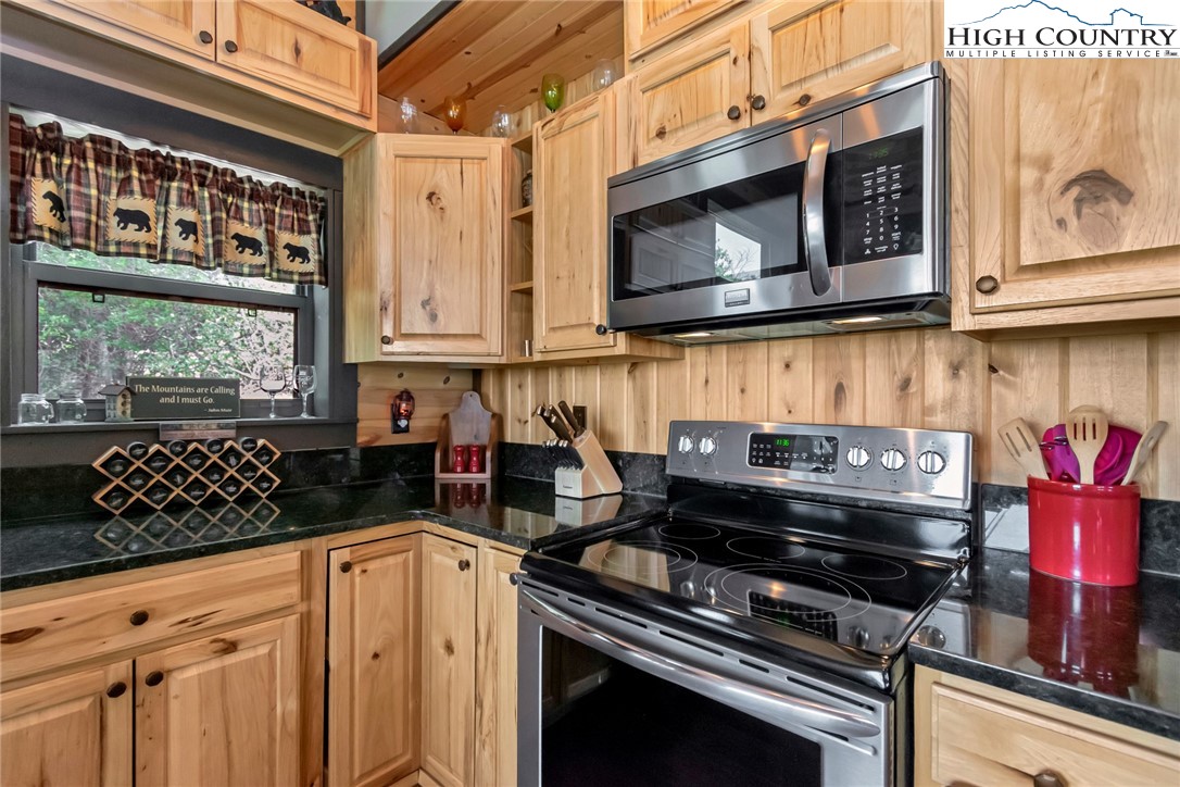 4879 Staghorn Road Purlear, NC 28665 - Photo 24 of 50 a kitchen with stainless steel appliances a stove and a microwave