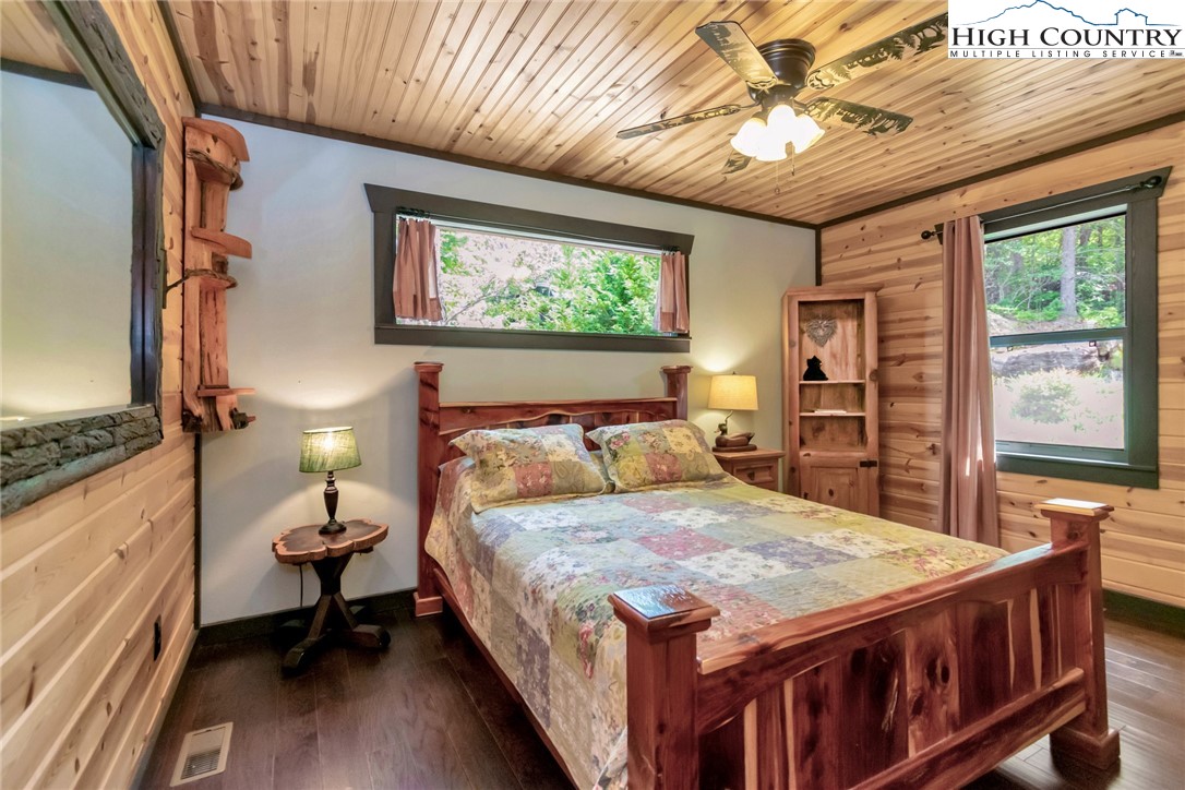 4879 Staghorn Road Purlear, NC 28665 - Photo 29 of 50 a bedroom with a bed a dresser next to a window