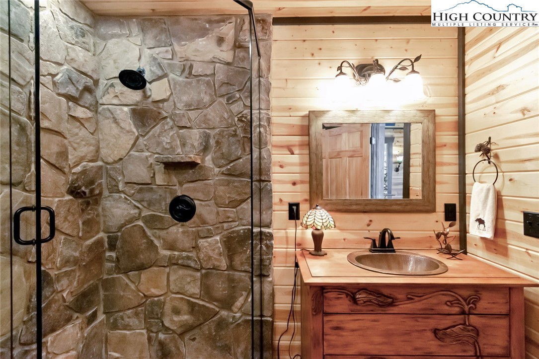 4879 Staghorn Road Purlear, NC 28665 - Photo 32 of 50 a bathroom with a sink a mirror and shower
