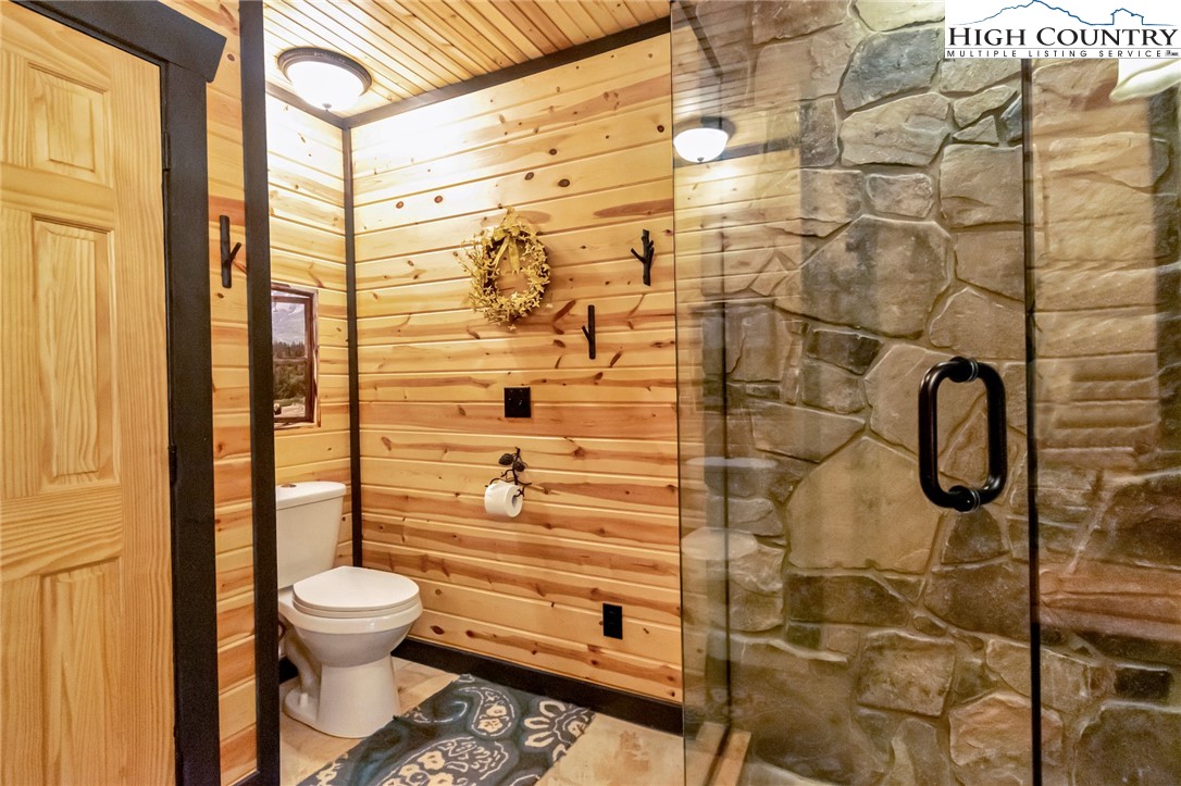 4879 Staghorn Road Purlear, NC 28665 - Photo 34 of 50 a bathroom with a toilet and a shower