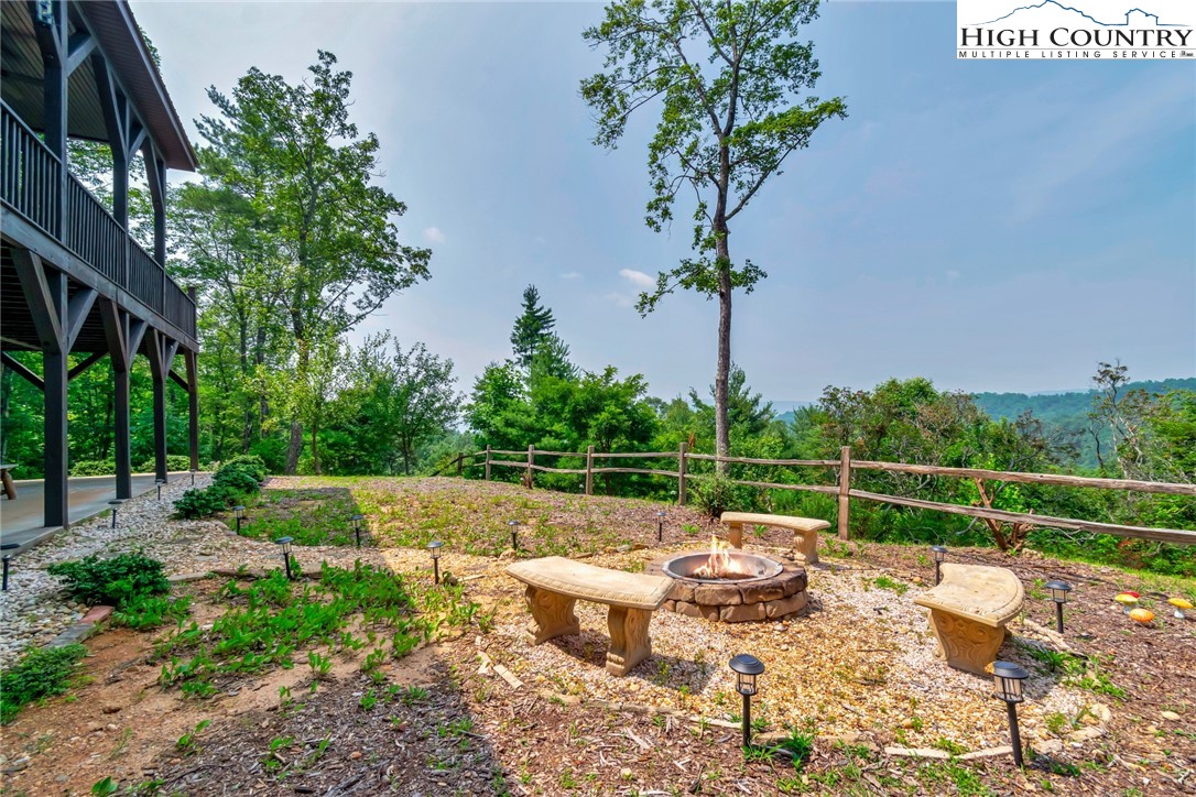 4879 Staghorn Road Purlear, NC 28665 - Photo 36 of 50 a view of a terrace with couches and wooden fence