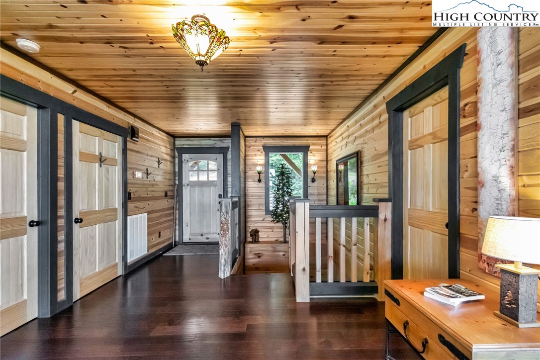4879 Staghorn Road Purlear, NC 28665 - Photo 6 of 50 a hallway with wooden floor and chandelier