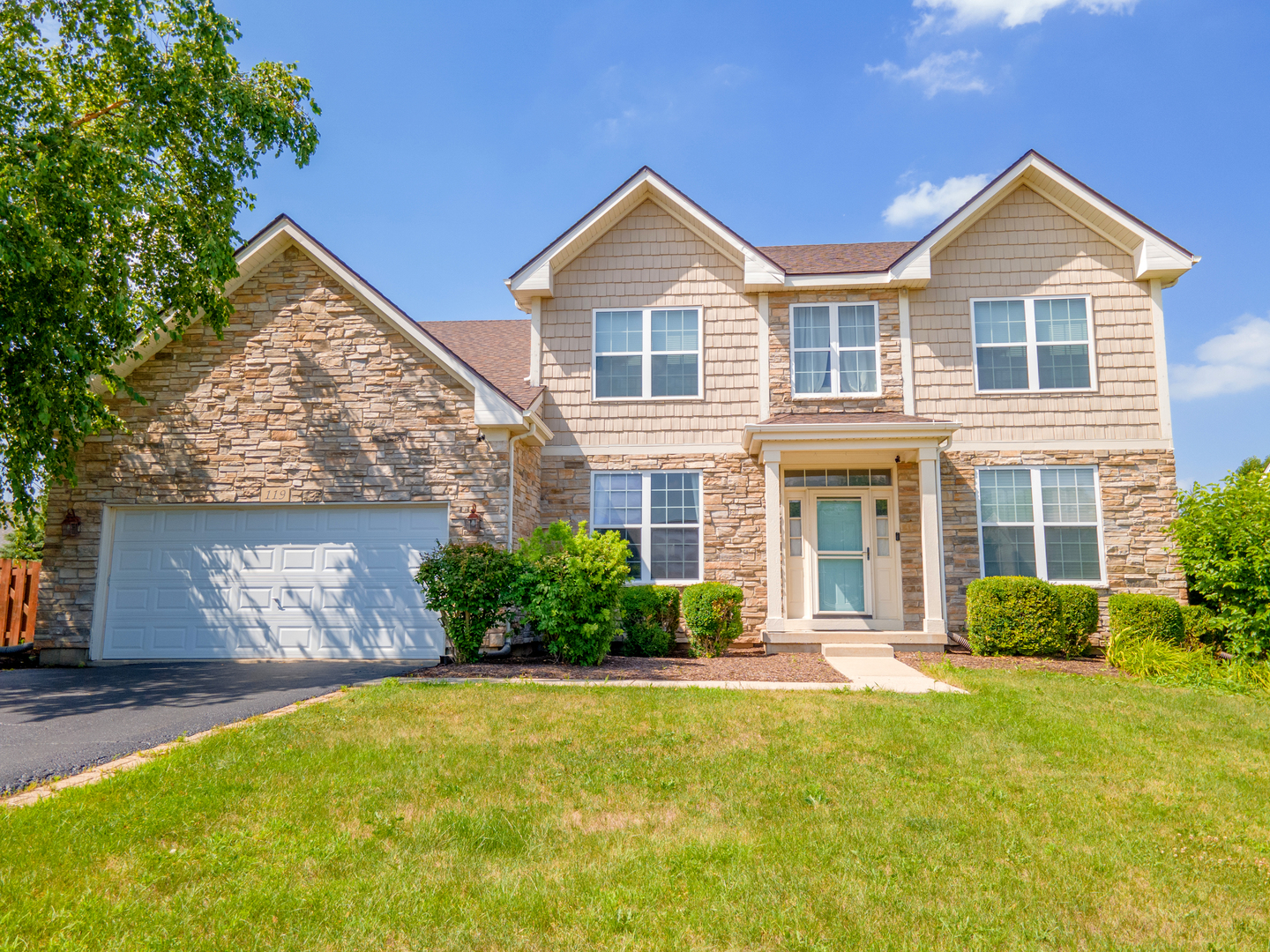 119 Reston Court Sycamore, IL 60178 - Photo 1 of 36 a front view of a house with a yard and garage