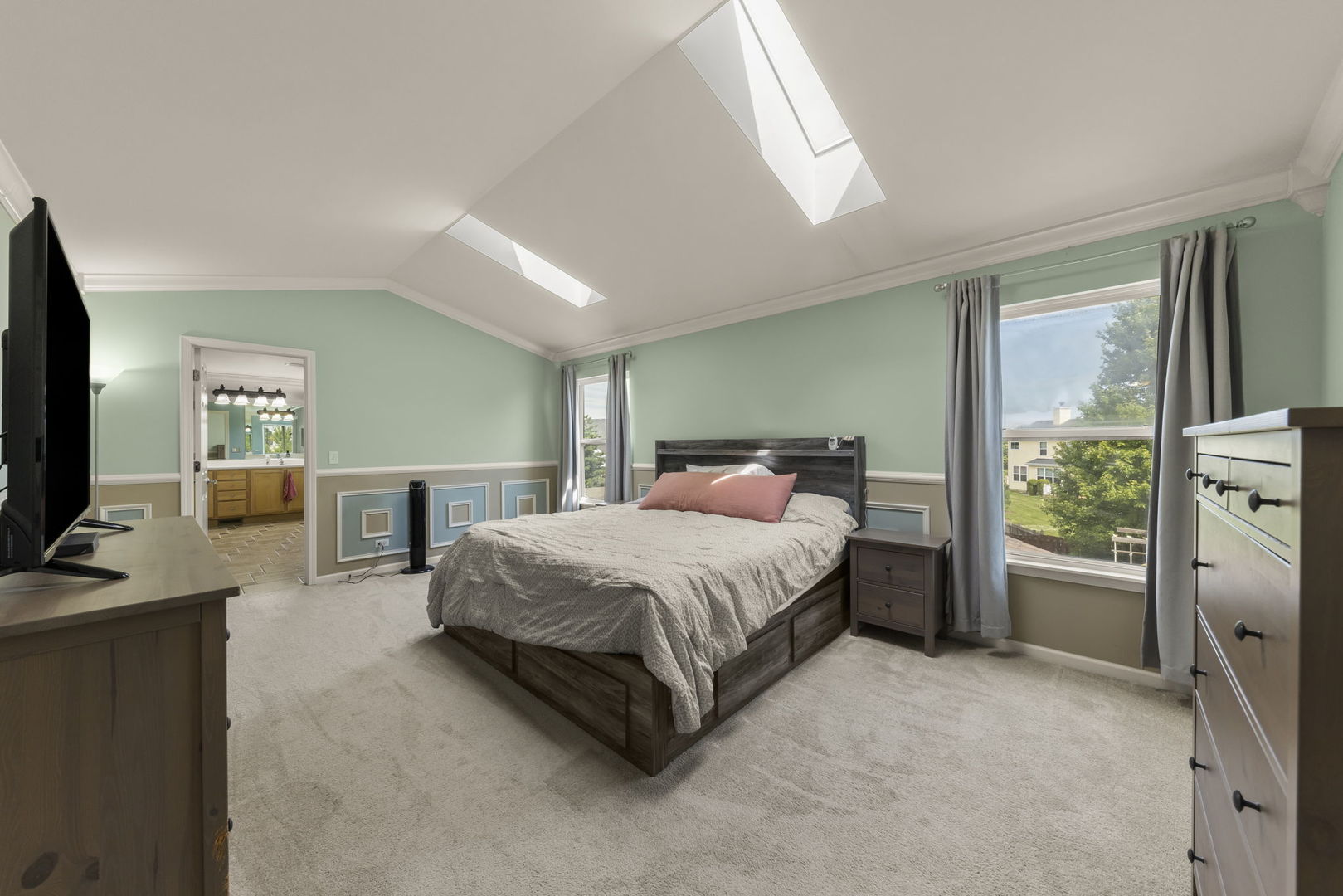 119 Reston Court Sycamore, IL 60178 - Photo 21 of 36 a spacious bedroom with a bed flat screen tv and windows