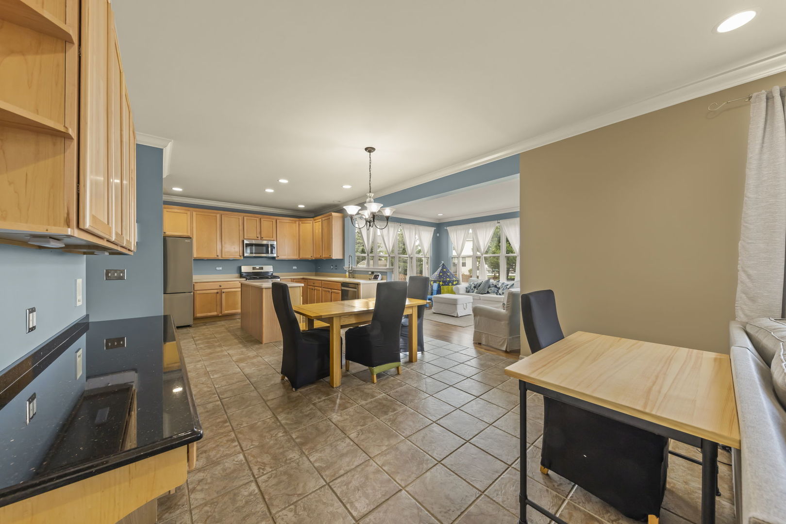 119 Reston Court Sycamore, IL 60178 - Photo 6 of 36 a kitchen with a table chairs refrigerator and cabinets