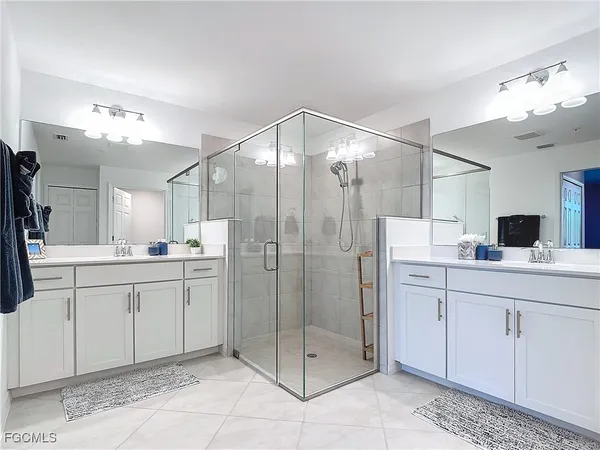 a bathroom with a shower sink and mirror