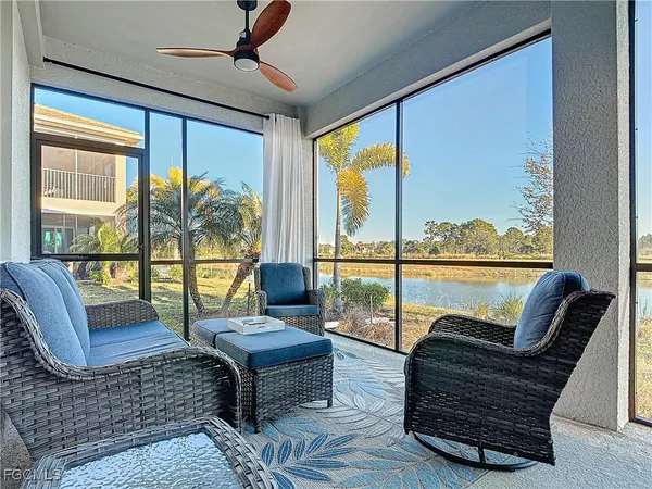 a living room with furniture and a floor to ceiling window