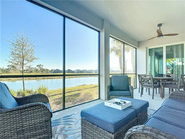 a living room with furniture and large windows