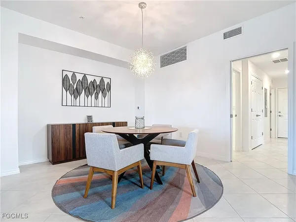 a view of a dining room with furniture wooden floor and a chandelier