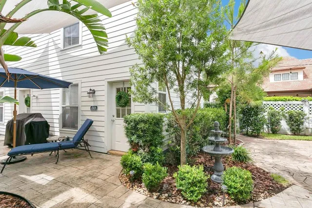 a view of a house with backyard porch and sitting area
