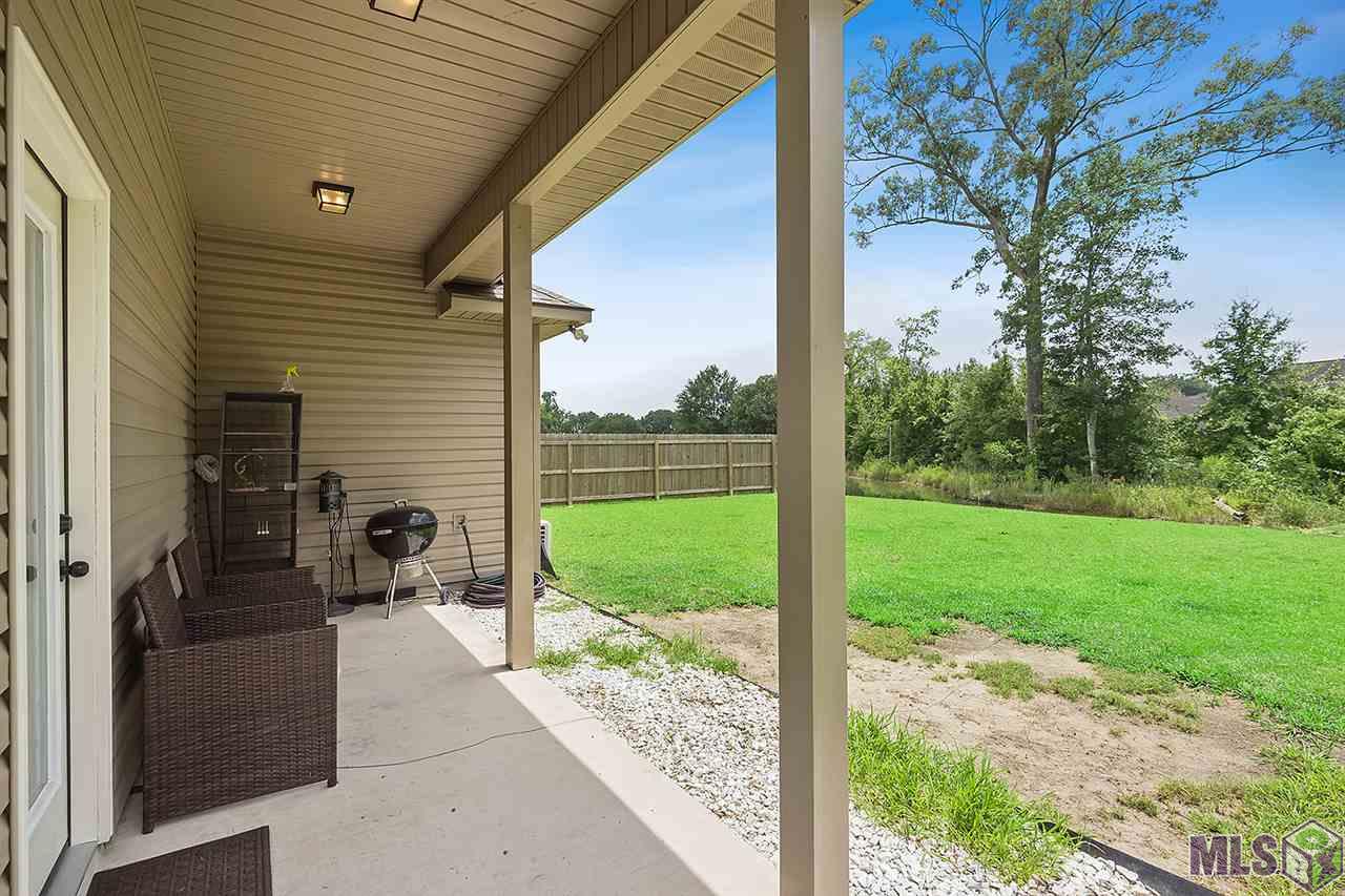 9036 Falling Oak Drive Baton Rouge, LA 70817 - Photo 20 of 21 Back covered porch overlooks yard and water