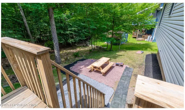 a view of a wooden deck and a backyard