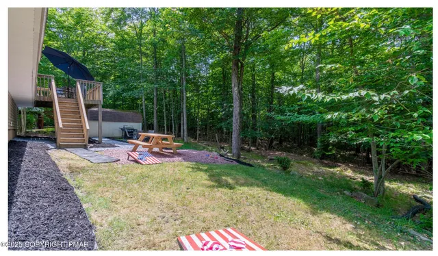 a view of a backyard with sitting area