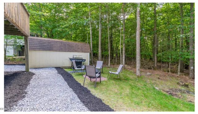a view of a house with backyard and sitting area