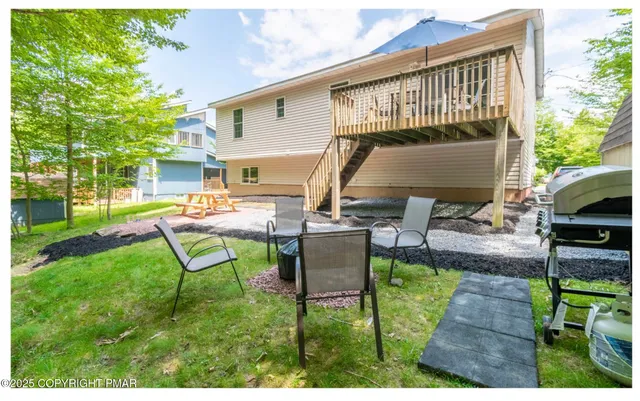 a view of a backyard with sitting area