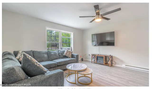 a living room with furniture and a flat screen tv