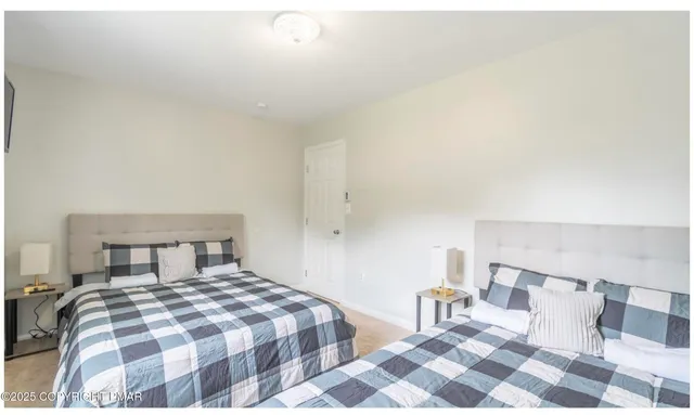 a bedroom with a bed and a lamp with the dresser