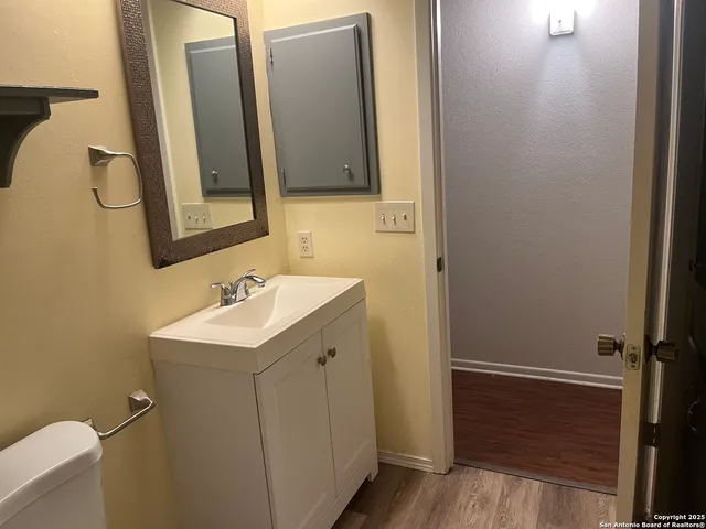 a bathroom with a sink a mirror and a toilet